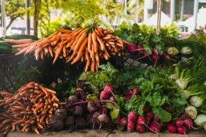 a pile of carrots, radishes, and other vegetables.