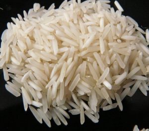 a pile of white rice sitting on top of a black table.