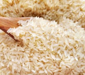 a wooden spoon in a bowl of white rice "Image of Herbocrop Exim's Best parboiled rice exporter