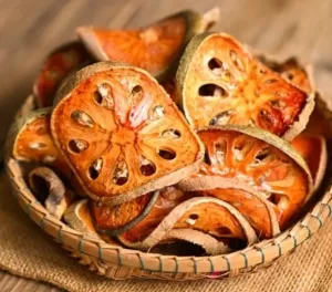 Dried Bael slices on basket background, Bael for Bael juice - Dry Bael fruit tea for health